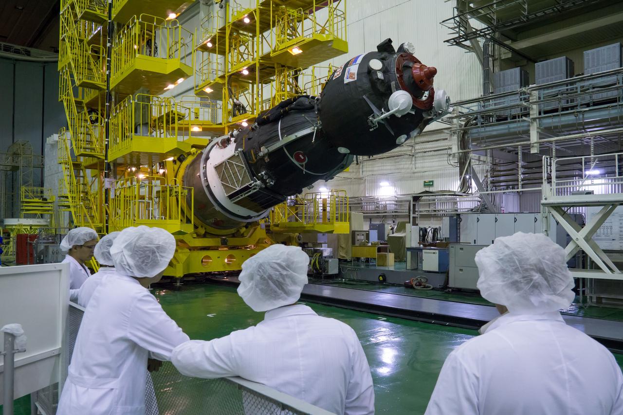 Workers watch as the Soyuz MS-02 spacecraft is lowered to a horizontal position in preparation for being encapsulated in its fairing on Thursday, Sept. 15, 2016 at the Baikonur Cosmodrome in Kazakhstan. Expedition 49 flight engineer Shane Kimbrough of NASA, flight engineer Andrey Borisenko of Roscosmos, and Soyuz commander Sergey Ryzhikov of Roscosmos are scheduled to launch to the International Space Station aboard the Soyuz MS-02 spacecraft from the Baikonur Cosmodrome on September 24 Kazakh time. Photo Credit: (NASA/Victor Zelentsov)