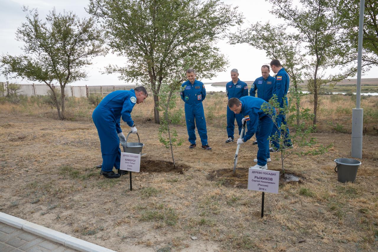 Expedition 49 flight engineer Shane Kimbrough of NASA left, and Soyuz commander Sergey Ryzhikov take part in the traditional tree planing ceremony at the Cosmonaut Hotel on Friday, Sept. 16, 2016 in Baikonur, Kazakhstan. Kimbrough, Ryzhikov and flight engineer Andrey Borisenko of Roscosmos are scheduled to launch to the International Space Station aboard the Soyuz MS-02 spacecraft from the Baikonur Cosmodrome on September 24 Kazakh time. Photo Credit: (NASA/Victor Zelentsov)