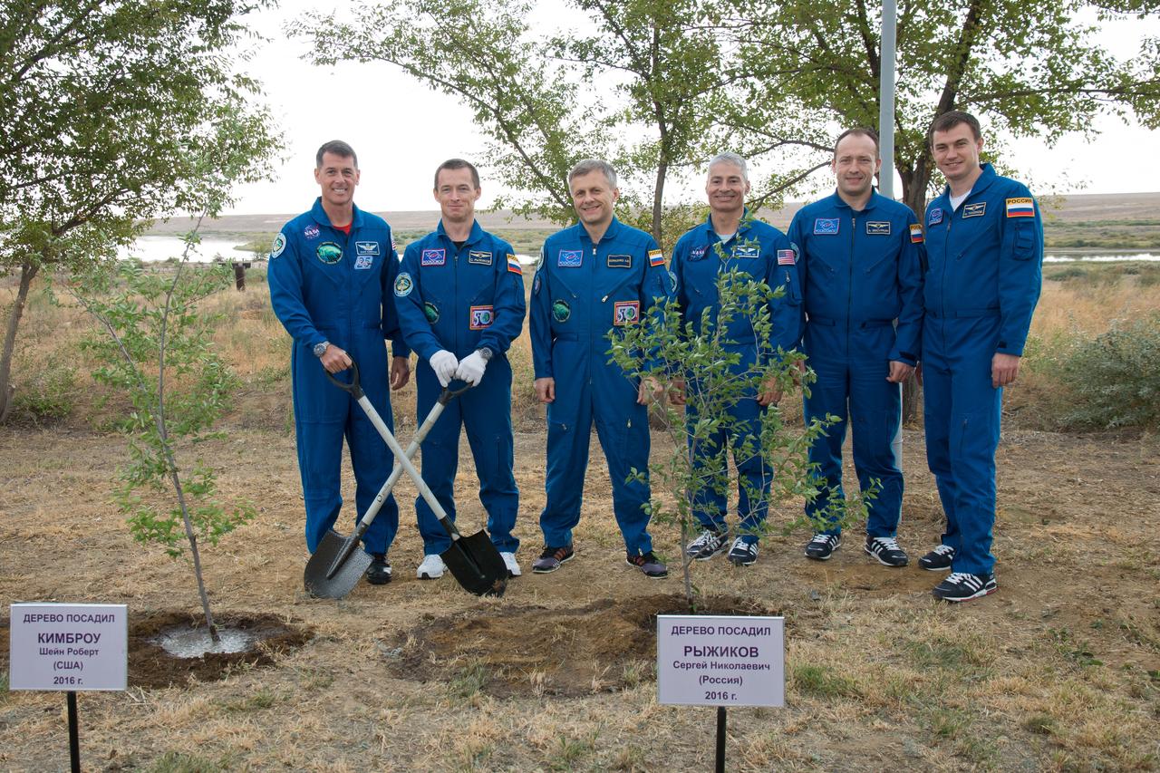 Expedition 49 flight engineer Shane Kimbrough of NASA, left, Soyuz commander Sergey Ryzhikov of Roscosmos, second from left, and flight engineer Andrey Borisenko of Roscosmos third from left, pose for a picture with backup crew members Mark Vande Hei of NASA, third from right, Alexander Misurkin of Roscosmos, second from right, and Nikolai Tikhonov of Roscosmos, right, after taking part in the traditional tree planing ceremony at the Cosmonaut Hotel on Friday, Sept. 16, 2016 in Baikonur, Kazakhstan. Kimbrough, Ryzhikov, and Borisenko are scheduled to launch to the International Space Station aboard the Soyuz MS-02 spacecraft from the Baikonur Cosmodrome on September 24 Kazakh time. Photo Credit: (NASA/Victor Zelentsov)