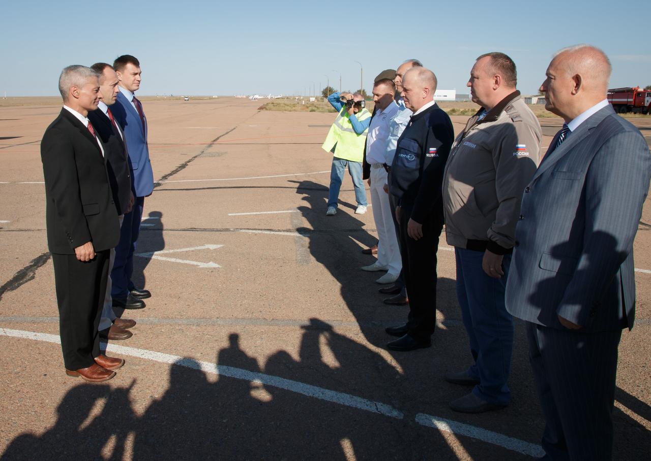 Expedition 49 backup crew members Mark Vande Hei of NASA, left, Alexander Misurkin, center, and Nikolai Tikhonov of Roscomos, left, report to Russian space officials after arriving in Baikonur, Kazakhstan on Friday, Oct. 7, 2016. The trio are preparing for launch to the International Spacestation in their Soyuz MS-02 spacecraft from the Baikonur Cosmodrome in Kazakhstan on October 19, 2016. Photo Credit: (NASA/Victor Zelentsov)
