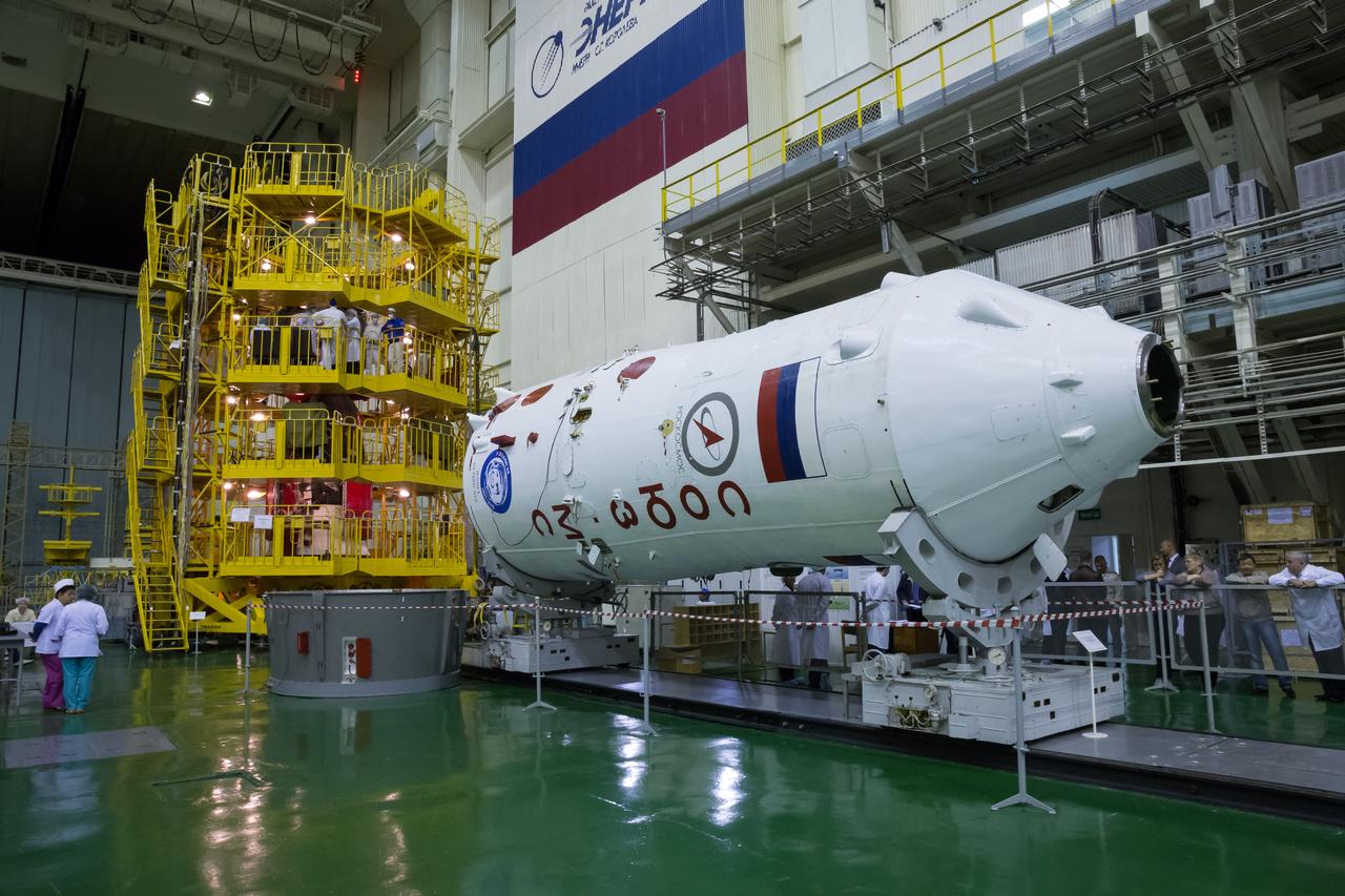 The Soyuz fairing is seen laying horizontal in front the of the Soyuz MS-02 spacecraft as Expedition 49 flight engineer Shane Kimbrough of NASA, Soyuz commander Sergey Ryzhikov of Roscosmos, and flight engineer Andrey Borisenko of Roscosmos perform their fit checks, Saturday, Oct. 8, 2016 at the Baikonur Cosmodrome in Kazakhstan. Kimbrought, Ryzhikov, and Borisenko will launch from the Baikonur Cosmodrome in Kazakhstan on Oct. 19. Photo Credit: (NASA/Victor Zelentsov)