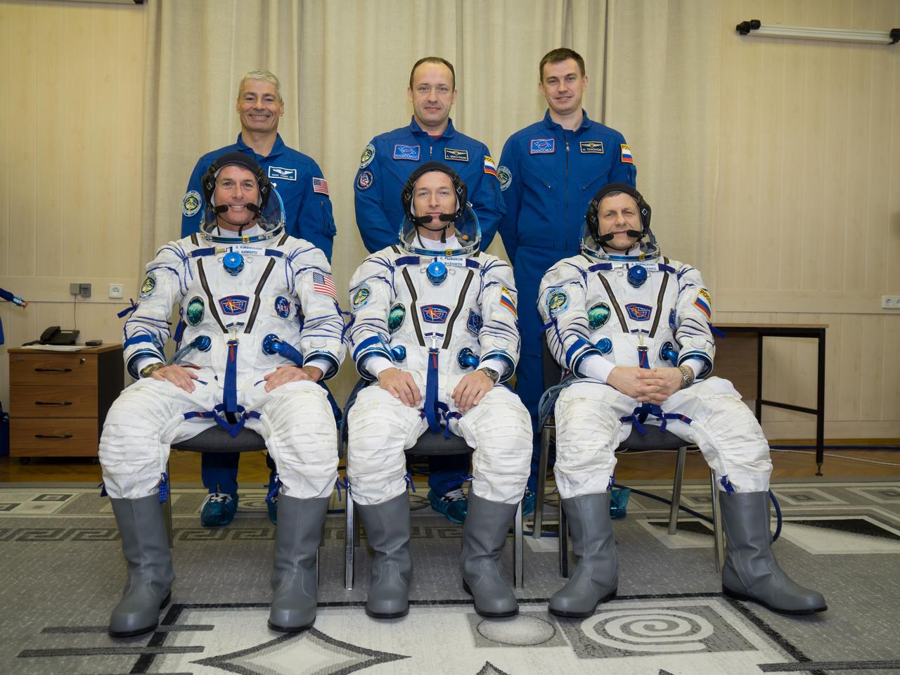 Expedition 49 prime crew members, seated in their Sokol suits, Shane Kimbrough of NASA, left, Soyuz commander Sergey Ryzhikov, center, and flight engineer Andrey Borisenko of Roscosmos, right, and backup crew members, standing, Mark Vande Hei of NASA, left, Alexander Misurkin, center, and Nikolai Tikhonov of Roscosmos, left, pose for a picture as they prepare to conduct their first check dress rehearsal activities, Saturday, Oct. 8, 2016 at the Baikonur Cosmodrome in Kazakhstan. Kimbrough, Ryzhikov, and Borsenko will launch from the Baikonur Cosmodrome in Kazakhstan on Oct. 19. Photo Credit: (NASA/Victor Zelentsov)