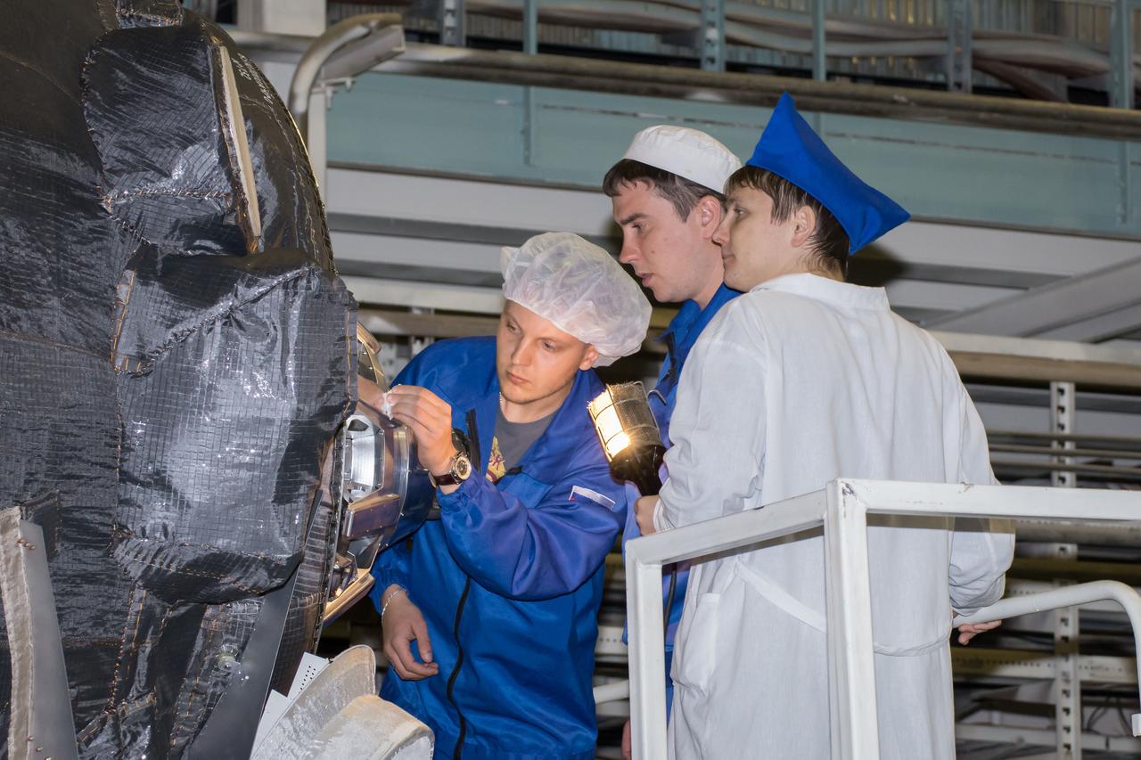 Workers prepare the Soyuz MS-02 spacecraft for encapsulation in its fairing on Thursday, Tuesday, Oct. 11, 2016 at the Baikonur Cosmodrome in Kazakhstan. Expedition 49 flight engineer Shane Kimbrough of NASA, flight engineer Andrey Borisenko of Roscosmos, and Soyuz commander Sergey Ryzhikov of Roscosmos are scheduled to launch from the Baikonur Cosmodrome in Kazakhstan on Oct. 19. Photo Credit: (NASA/Victor Zelentsov)