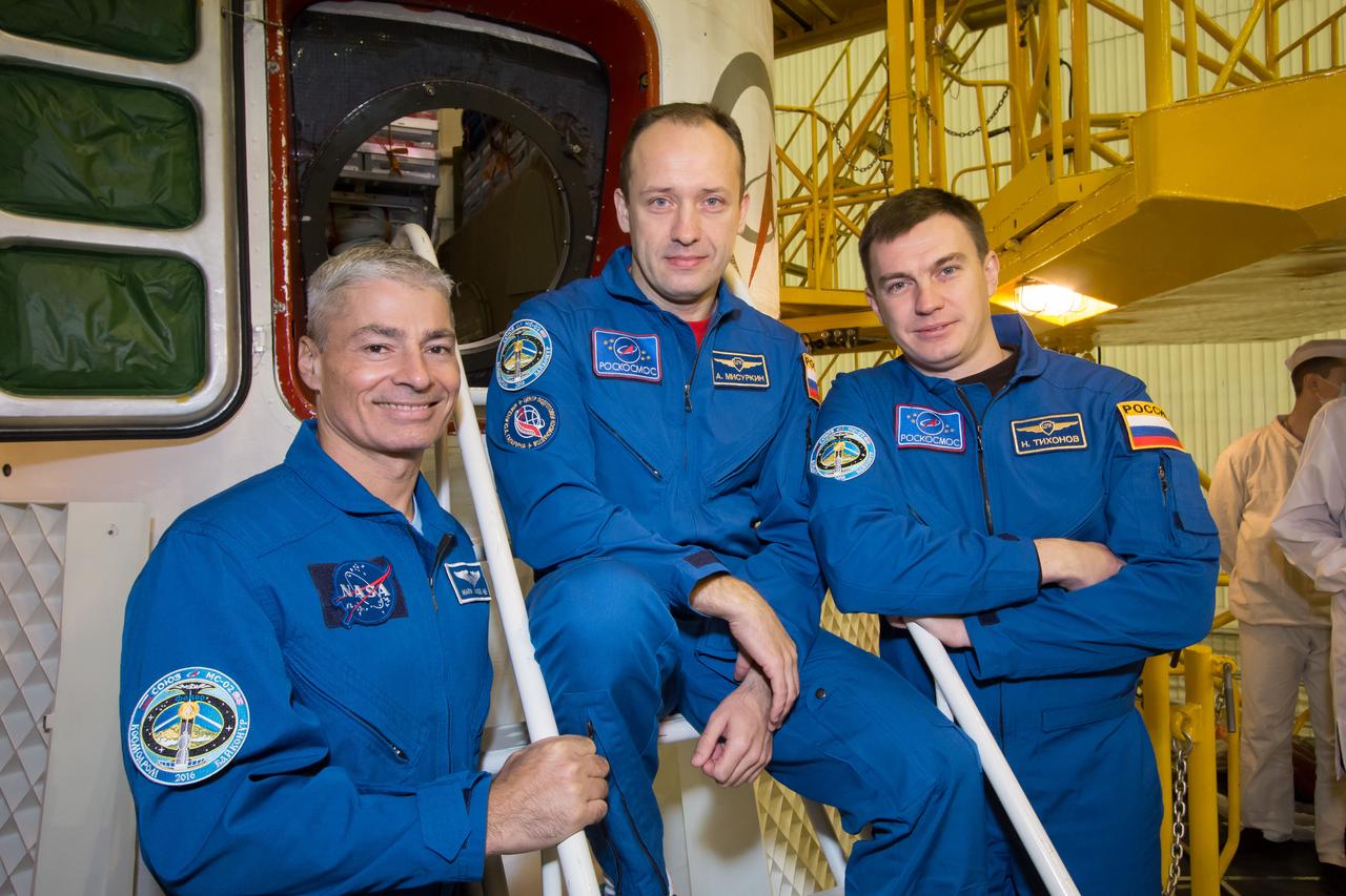 Expedition 49 backup crew members Mark Vande Hei of NASA, left, Alexander Misurkin Soyuz, center, and Nikolai Tikhonov of Roscosmos, right, pose for a picture in front of the Soyuz MS-02 spacecraft during the final fit check of the spacecraft on Thursday, Oct. 13, 2016 at the Baikonur Cosmodrome in Kazakhstan. Expedition 49 flight engineer Shane Kimbrough of NASA, flight engineer Andrey Borisenko of Roscosmos, and Soyuz commander Sergey Ryzhikov of Roscosmos are scheduled to launch from the Baikonur Cosmodrome in Kazakhstan on Oct. 19. Photo Credit: (NASA/Victor Zelentsov)