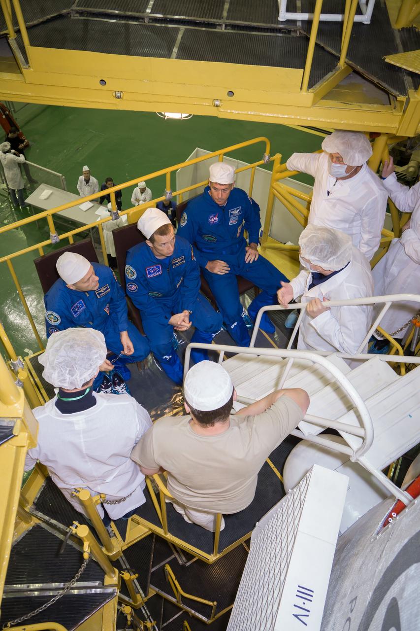 Expedition 49 crew members Andrey Borisenko of Roscosmos, left, Sergey Ryzhikov of Roscosmos, center, and Shane Kimbrough, right, speak with technicians in front of their Soyuz MS-02 spacecraft during the final fit check of the spacecraft on Thursday, Oct. 13, 2016 at the Baikonur Cosmodrome in Kazakhstan. Kimbrough, Ryzhikov, and Borisenko are scheduled to launch from the Baikonur Cosmodrome in Kazakhstan on Oct. 19. Photo Credit: (NASA/Victor Zelentsov)