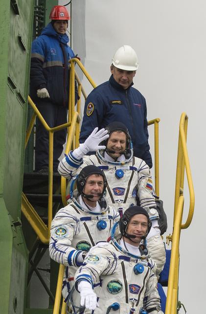 Expedition 49 flight engineer Andrey Borisenko of Roscosmos, top, flight engineer Shane Kimbrough of NASA, middle, and Soyuz commander Sergey Ryzhikov of Roscosmos, bottom, climb the ladder to the elevator as they prepare to board the Soyuz MS-02 rocket for launch, Wednesday, Oct. 19, 2016 at the Baikonur Cosmodrome in Kazakhstan. Kimbrough, Borisenko, and Ryzhikov will spend the next four months living and working aboard the International Space Station. Photo Credit: (NASA/Joel Kowsky)