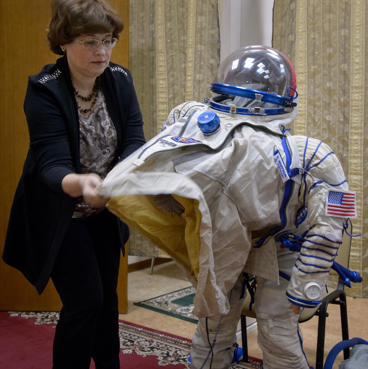 Expedition 50 NASA astronaut Peggy Whitson dons her Sokol suit ahead of her final qualification exams with fellow crew mates Russian cosmonaut Oleg Novitskiy of Roscosmos and ESA astronaut Thomas Pesquet, Tuesday, Oct. 25, 2016, at the Gagarin Cosmonaut Training Center (GCTC) in Star City, Russia. Photo Credit: (NASA/Bill Ingalls)