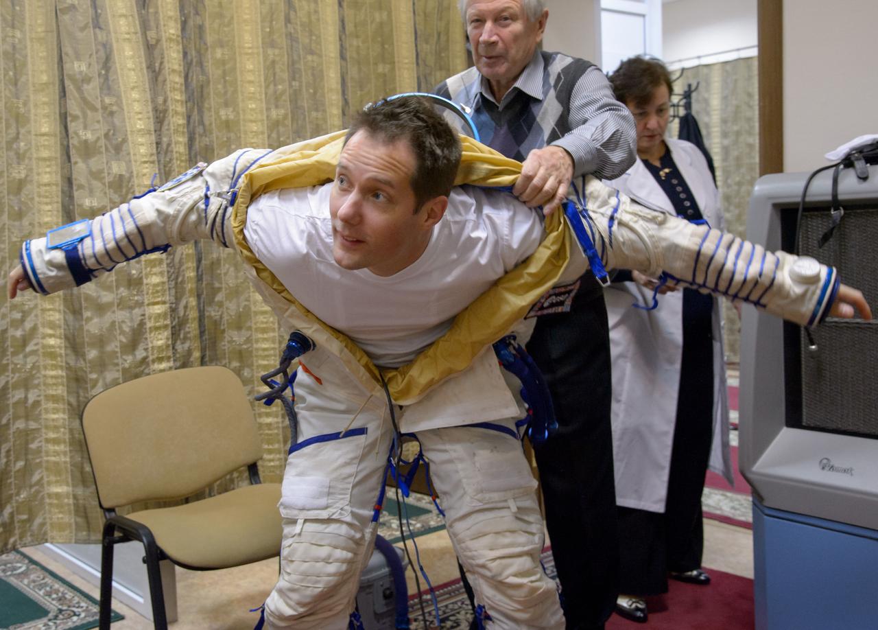 Expedition 50 ESA astronaut Thomas Pesquet dons his Sokol suit ahead of his final qualification exams with fellow crew mates NASA astronaut Peggy Whitson and Russian cosmonaut Oleg Novitskiy of Roscosmos, Tuesday, Oct. 25, 2016, at the Gagarin Cosmonaut Training Center (GCTC) in Star City, Russia. Photo Credit: (NASA/Bill Ingalls)