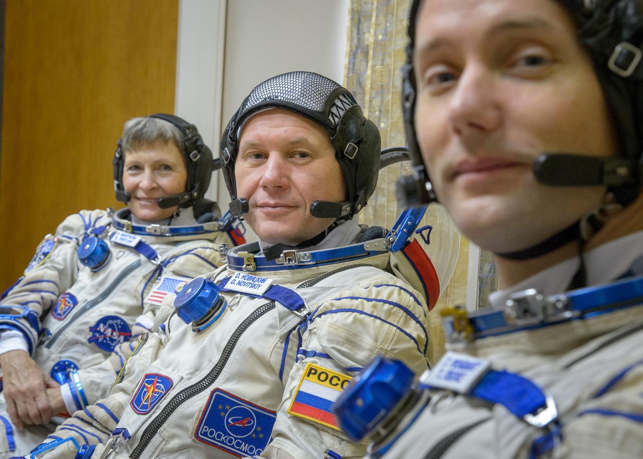 Expedition 50 crew members NASA astronaut Peggy Whitson, left, Russian cosmonaut Oleg Novitskiy of Roscosmos, center, and ESA astronaut Thomas Pesquet pose for a portrait ahead of their final qualification exams, Tuesday, Oct. 25, 2016, at the Gagarin Cosmonaut Training Center (GCTC) in Star City, Russia. Photo Credit: (NASA/Bill Ingalls)