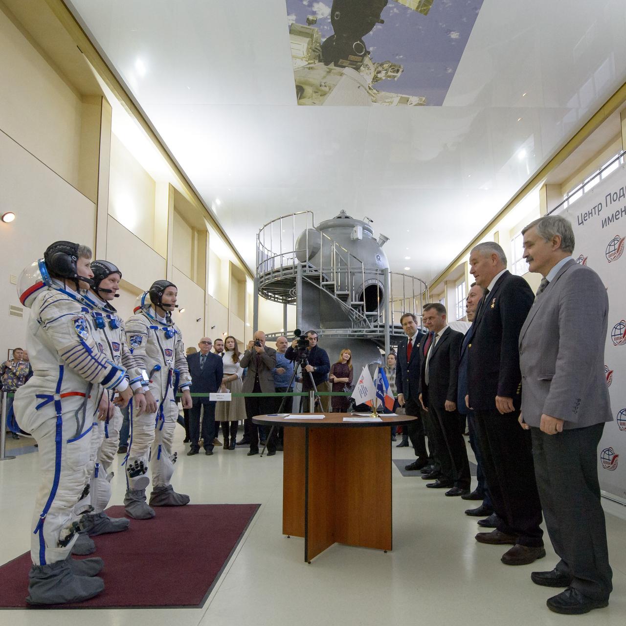 Expedition 50 crew members NASA astronaut Peggy Whitson, left, Russian cosmonaut Oleg Novitskiy of Roscosmos, center, and ESA astronaut Thomas Pesquet report to mission managers for their final qualification exams, Tuesday, Oct. 25, 2016, at the Gagarin Cosmonaut Training Center (GCTC) in Star City, Russia. Photo Credit: (NASA/Bill Ingalls)