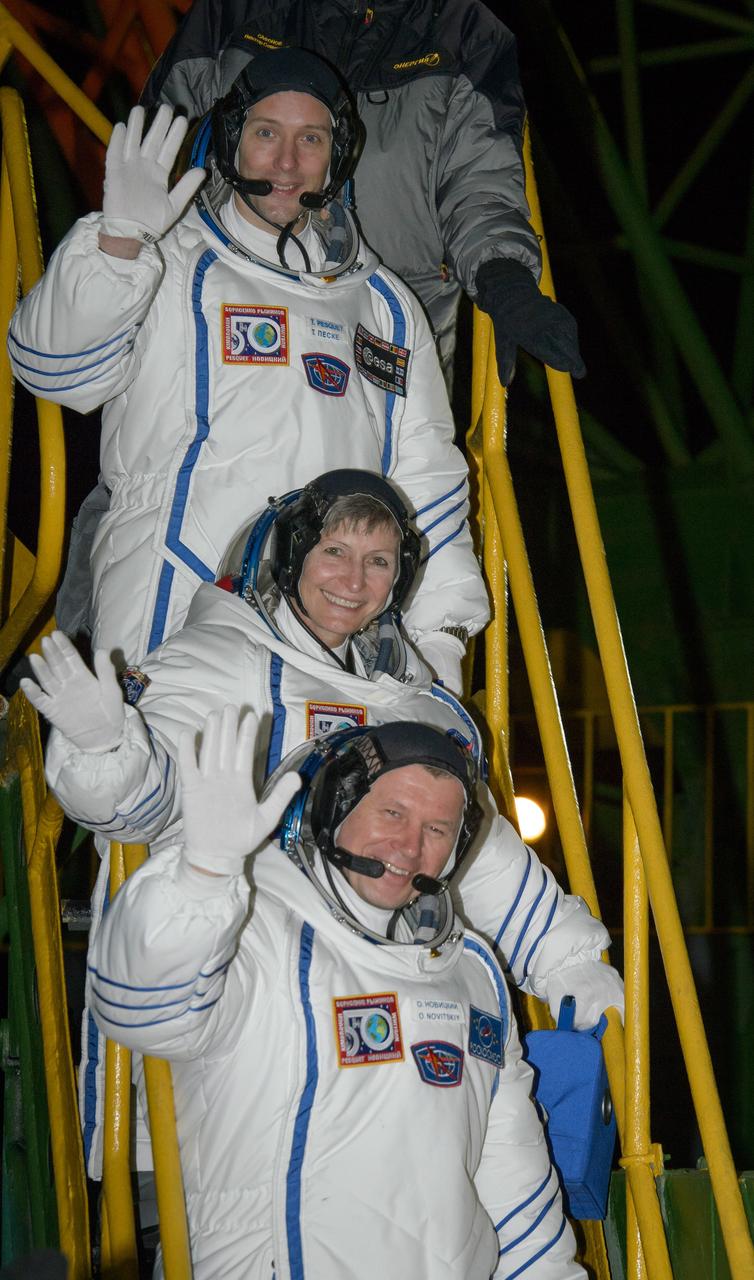 nhq201611170001 (Nov. 17, 2016) --- Expedition 50 crewmembers ESA astronaut Thomas Pesquet, top, NASA astronaut Peggy Whitson, middle, and Russian cosmonaut Oleg Novitskiy of Roscosmos wave farewell before boarding their Soyuz MS-03 spacecraft for launch Thursday, Nov. 17, 2016, (Kazakh Time) in Baikonur, Kazakhstan. The trio will launch from the Baikonur Cosmodrome in Kazakhstan the morning of November 18 (Kazakh time.) All three will spend approximately six months on the orbital complex. Photo Credit: (NASA/Bill Ingalls)