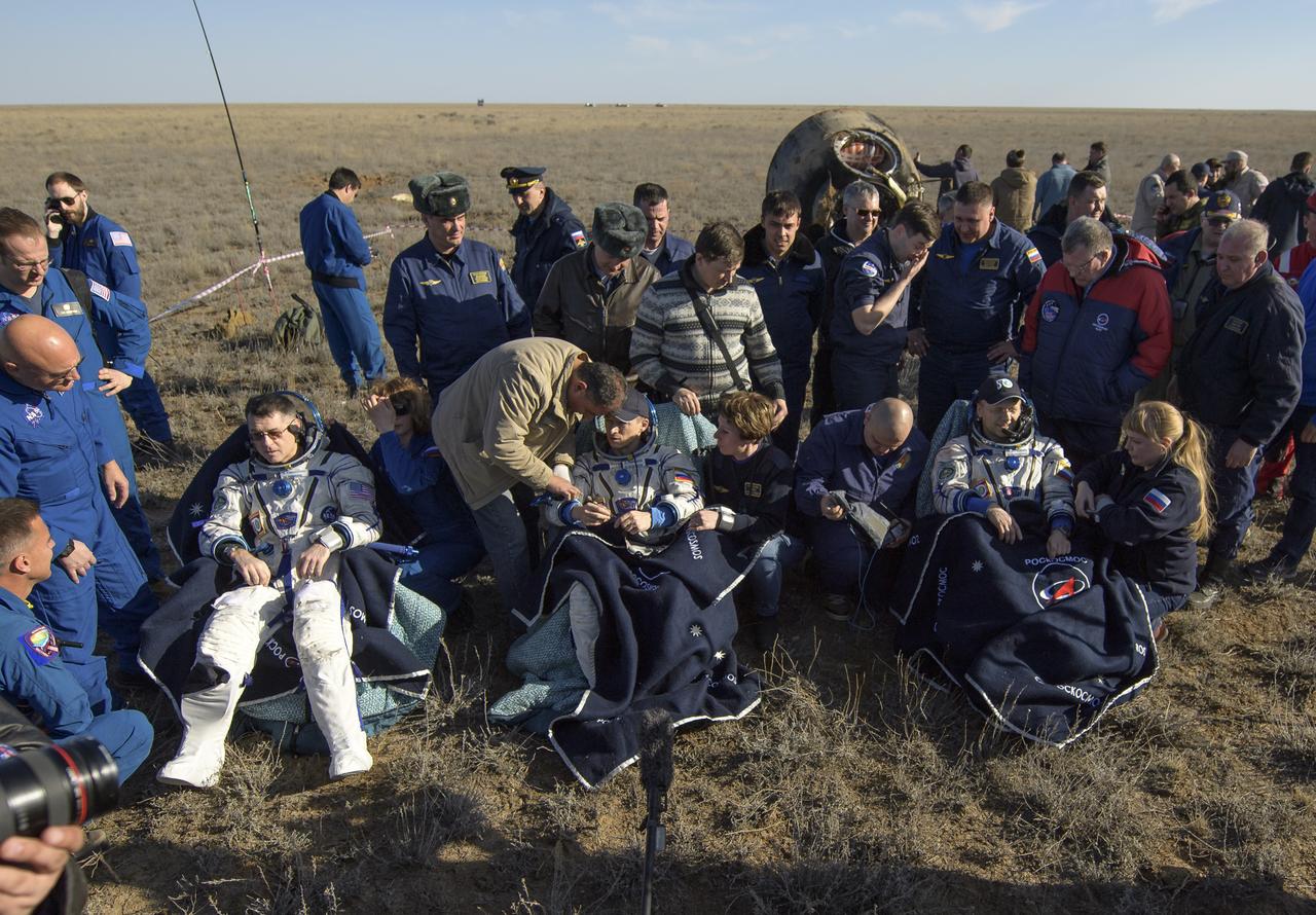 nhq201704100002 (April 10, 2017) --- NASA astronaut Shane Kimbrough, left, Russian cosmonaut Sergey Ryzhikov of Roscosmos, center, and Russian cosmonaut Andrey Borisenko of Roscosmos sit in chairs outside the Soyuz MS-02 spacecraft a few moments after they landed in a remote area near the town of Zhezkazgan, Kazakhstan on Monday, April 10, 2017 (Kazakh time). Kimbrough, Ryzhikov, and Borisenko are returning after 173 days in space where they served as members of the Expedition 49 and 50 crews onboard the International Space Station. Photo Credit: (NASA/Bill Ingalls)