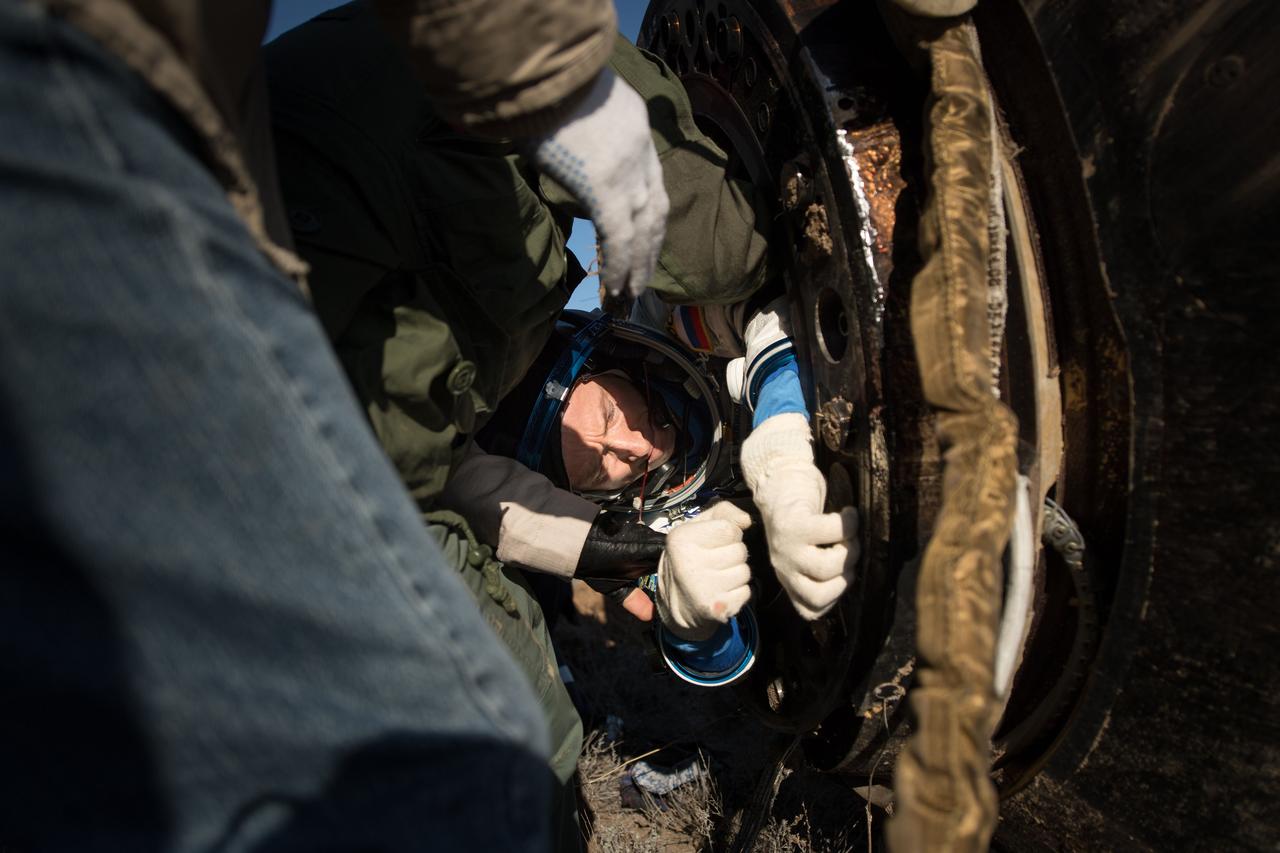 nhq201704100023 (April 10, 2017) --- Russian cosmonaut Sergey Ryzhikov of Roscosmos is helped out of the Soyuz MS-02 spacecraft just minutes after he, NASA astronaut Shane Kimbrough, and Russian cosmonaut Andrey Borisenko of Roscosmos landed in a remote area near the town of Zhezkazgan, Kazakhstan on Monday, April 10, 2017 (Kazakh time). Kimbrough, Ryzhikov, and Borisenko are returning after 173 days in space where they served as members of the Expedition 49 and 50 crews onboard the International Space Station. Photo Credit: (NASA/Bill Ingalls)