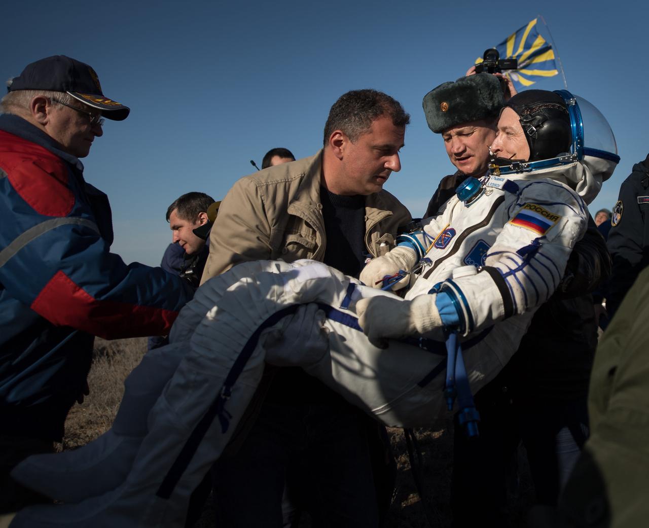 nhq201704100024 (April 10, 2017) --- Russian cosmonaut Sergey Ryzhikov of Roscosmos is helped out of the Soyuz MS-02 spacecraft just minutes after he, NASA astronaut Shane Kimbrough, and Russian cosmonaut Andrey Borisenko of Roscosmos landed in a remote area near the town of Zhezkazgan, Kazakhstan on Monday, April 10, 2017 (Kazakh time). Kimbrough, Ryzhikov, and Borisenko are returning after 173 days in space where they served as members of the Expedition 49 and 50 crews onboard the International Space Station. Photo Credit: (NASA/Bill Ingalls)