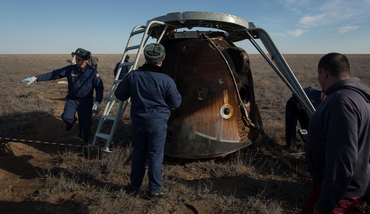 nhq201704100037 (April 10, 2017) --- Russian support personnel work around the Soyuz MS-02 spacecraft shortly after it landed with Expedition 50 Commander Shane Kimbrough of NASA and Flight Engineers Sergey Ryzhikov and Andrey Borisenko of Roscosmos near the town of Zhezkazgan, Kazakhstan on Monday, April 10, 2017 (Kazakh time). Kimbrough, Ryzhikov, and Borisenko are returning after 173 days in space where they served as members of the Expedition 49 and 50 crews onboard the International Space Station. Photo Credit: (NASA/Bill Ingalls)