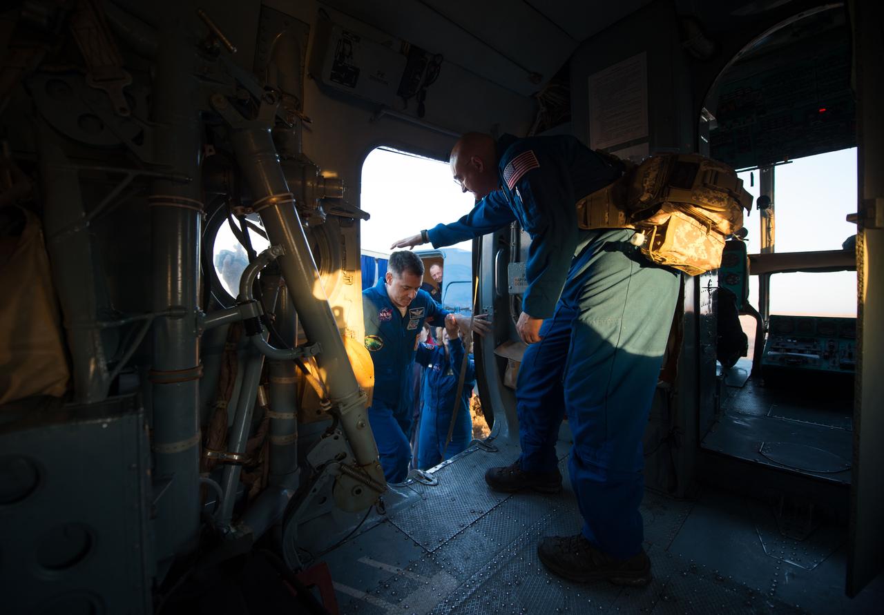 nhq201704100045 (April 10, 2017) --- NASA astronaut Shane Kimbrough, left, is helped into an awaiting Russian MI-8 helicopter by NASA flight doctor Blake Chamberlain shortly after he, Russian cosmonaut Sergey Ryzhikov of Roscosmos, and Russian cosmonaut Andrey Borisenko of Roscosmos landed in their Soyuz MS-02 spacecraft in a remote area near the town of Zhezkazgan, Kazakhstan on Monday, April 10, 2017 (Kazakh time). Kimbrough, Ryzhikov, and Borisenko are returning after 173 days in space where they served as members of the Expedition 49 and 50 crews onboard the International Space Station. Photo Credit: (NASA/Bill Ingalls)