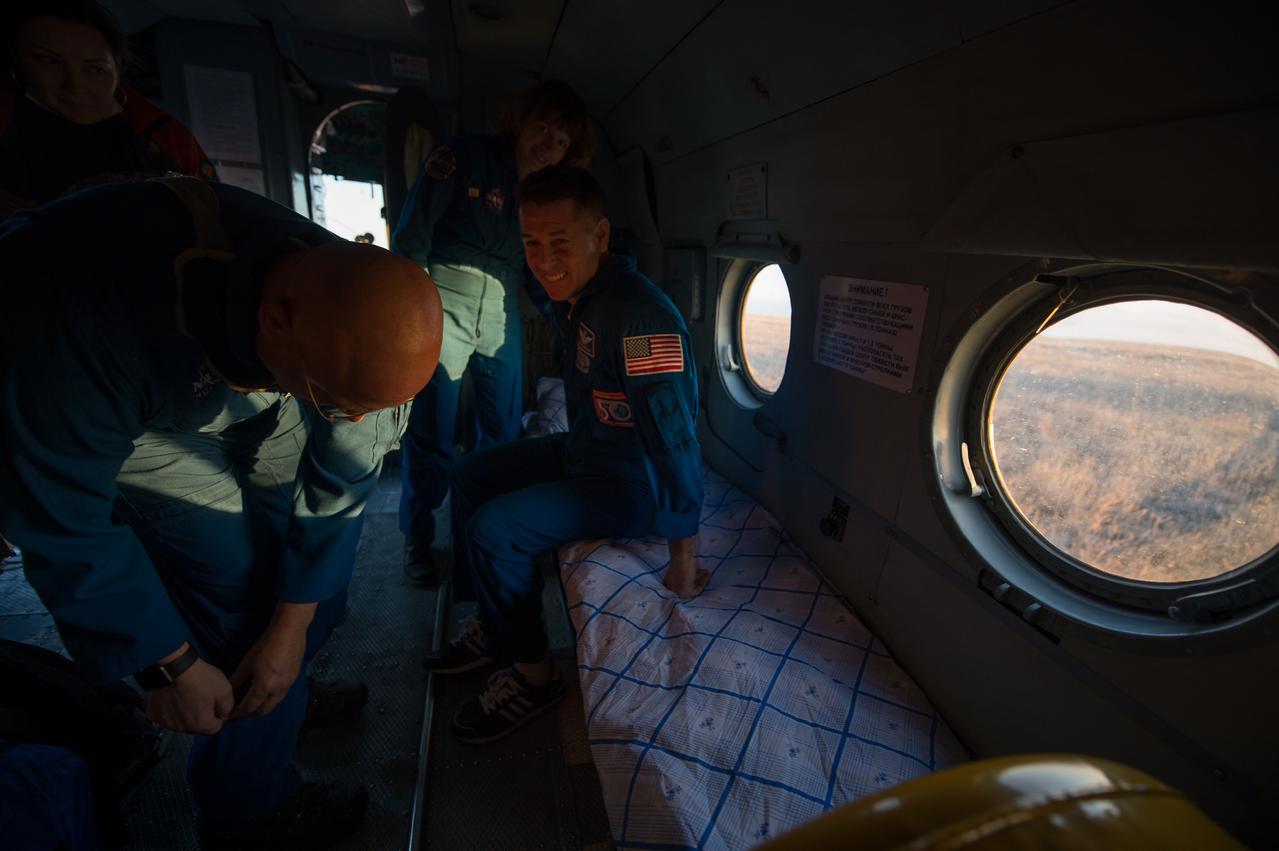 nhq201704100046 (April 10, 2017) --- NASA astronaut Shane Kimbrough, seated right, is seen inside a Russian MI-8 helicopter after he, Russian cosmonaut Sergey Ryzhikov of Roscosmos, and Russian cosmonaut Andrey Borisenko of Roscosmos landed in their Soyuz MS-02 spacecraft in a remote area near the town of Zhezkazgan, Kazakhstan on Monday, April 10, 2017 (Kazakh time). Kimbrough, Ryzhikov, and Borisenko are returning after 173 days in space where they served as members of the Expedition 49 and 50 crews onboard the International Space Station. Photo Credit: (NASA/Bill Ingalls)