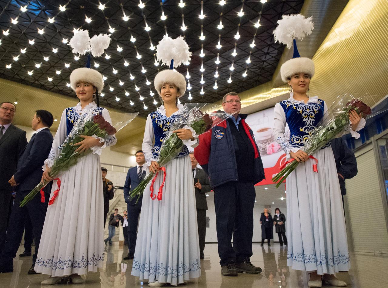nhq201704100049 (April 10, 2017) --- Girls in traditional Kazakhstan dress wait to welcome the return of Expedition 50 Commander Shane Kimbrough of NASA and Flight Engineers Sergey Ryzhikov and Andrey Borisenko of Roscosmos at a Karaganda Airport welcome ceremony in Kazakhstan on Monday, April 10, 2017. 2017 (Kazakh time). Kimbrough, Ryzhikov, and Borisenko are returning after 173 days in space where they served as members of the Expedition 49 and 50 crews onboard the International Space Station. Photo Credit: (NASA/Bill Ingalls)