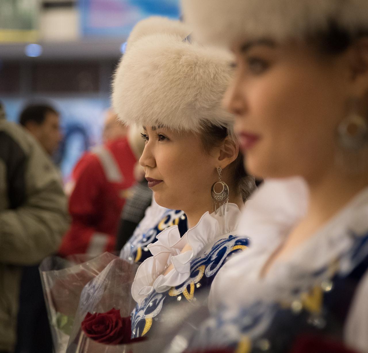 nhq201704100050 (April 10, 2017) --- Girls in traditional Kazakhstan dress wait to welcome the return of Expedition 50 Commander Shane Kimbrough of NASA and Flight Engineers Sergey Ryzhikov and Andrey Borisenko of Roscosmos at a Karaganda Airport welcome ceremony in Kazakhstan on Monday, April 10, 2017. 2017 (Kazakh time). Kimbrough, Ryzhikov, and Borisenko are returning after 173 days in space where they served as members of the Expedition 49 and 50 crews onboard the International Space Station. Photo Credit: (NASA/Bill Ingalls)