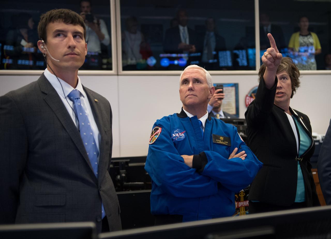 nhq201706070007  (06/07/2017)  ---Vice President Mike Pence, center, listens to NASA Deputy Chief Flight Director Holly Ridings, right, and NASA Flight Director Rick Henfling during a tour of the Christopher C. Kraft Jr. Mission Control Center, Wednesday, June 7, 2017 at NASA’s Johnson Space Center in Houston, Texas. The Vice President was at the space center to welcome America’s newest astronaut candidates, chosen from more than 18,300 applicants to carry the torch for future human space exploration. After completing two years of training, the new astronaut candidates could be assigned to missions performing research on the International Space Station, launching from American soil on spacecraft built by commercial companies, and launching on deep space missions on NASA’s new Orion spacecraft and Space Launch System rocket. Photo Credit: (NASA/Bill Ingalls)