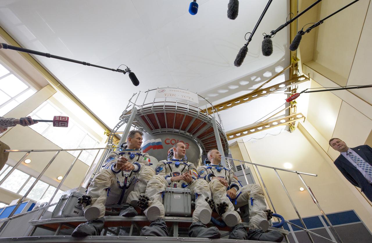 nhq201707070008 (July 7, 2017) --- Expedition 52 flight engineers Paolo Nespoli of ESA, left, Sergey Ryazanskiy of Roscosmos, and Randy Bresnik of NASA answer questions from the press outside the Soyuz simulator ahead of their final Soyuz qualification exam, Friday, July 7, 2017 at the Gagarin Cosmonaut Training Center (GCTC) in Star City, Russia. Photo Credit: (NASA/Bill Ingalls)