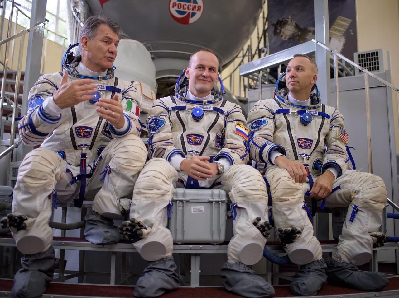 nhq201707070010 (July 7, 2017) --- Expedition 52 flight engineers Paolo Nespoli of ESA, left, Sergey Ryazanskiy of Roscosmos, and Randy Bresnik of NASA answer questions from the press outside the Soyuz simulator ahead of their final Soyuz qualification exam, Friday, July 7, 2017 at the Gagarin Cosmonaut Training Center (GCTC) in Star City, Russia. Photo Credit: (NASA/Bill Ingalls)