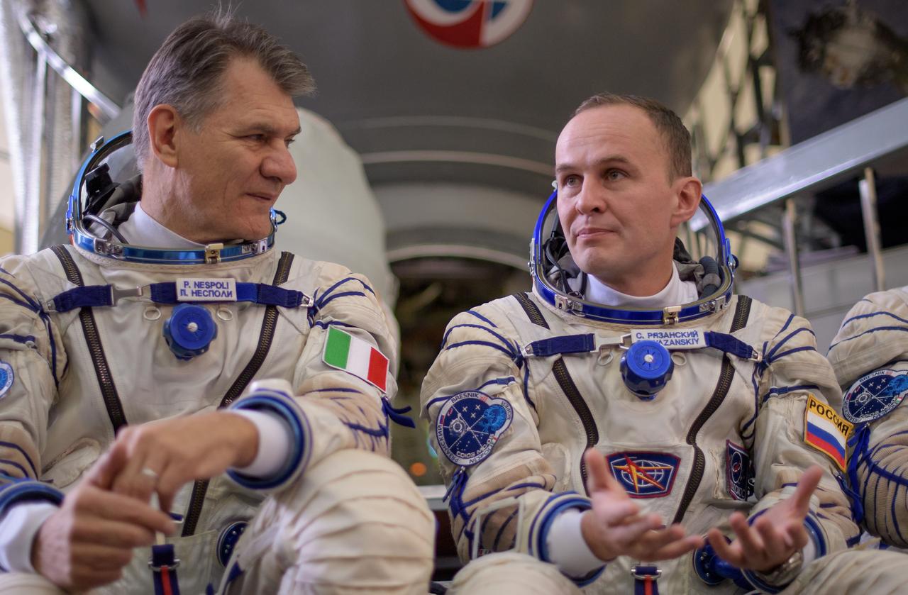 nhq201707070011 (July 7, 2017) --- Expedition 52 flight engineers Paolo Nespoli of ESA, left, and Sergey Ryazanskiy of Roscosmos answer questions from the press outside the Soyuz simulator ahead of their final Soyuz qualification exam with fellow Expedition 52 flight engineer Randy Bresnik of NASA, Friday, July 7, 2017 at the Gagarin Cosmonaut Training Center (GCTC) in Star City, Russia. Photo Credit: (NASA/Bill Ingalls)