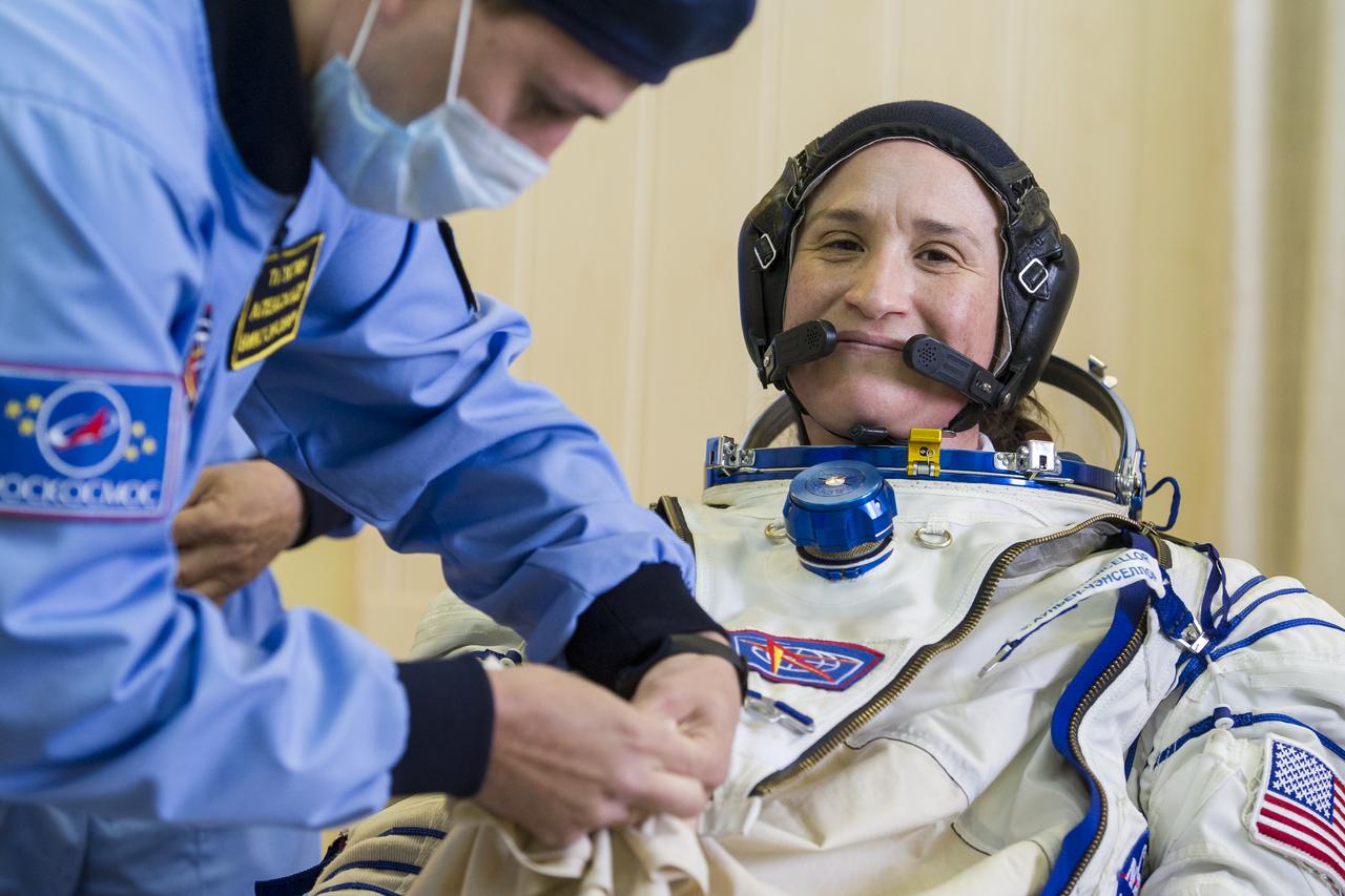 Expedition 56 flight engineer Serena Auñón-Chancellor of NASA is helped into her Russian Sokol suit as she and fellow crewmates, Sergey Prokopyev of Roscosmos and Alexander Gerst of ESA (European Space Agency) prepare for their Soyuz launch to the International Space Station Wednesday, June 6, 2018 at the Baikonur Cosmodrome in Kazakhstan.  Launch of the Soyuz rocket will send Auñón-Chancellor, Prokopyev, and Gerst on a six month mission aboard the International Space Station. Photo Credit: (NASA/GCTC/Andrey Shelepin)