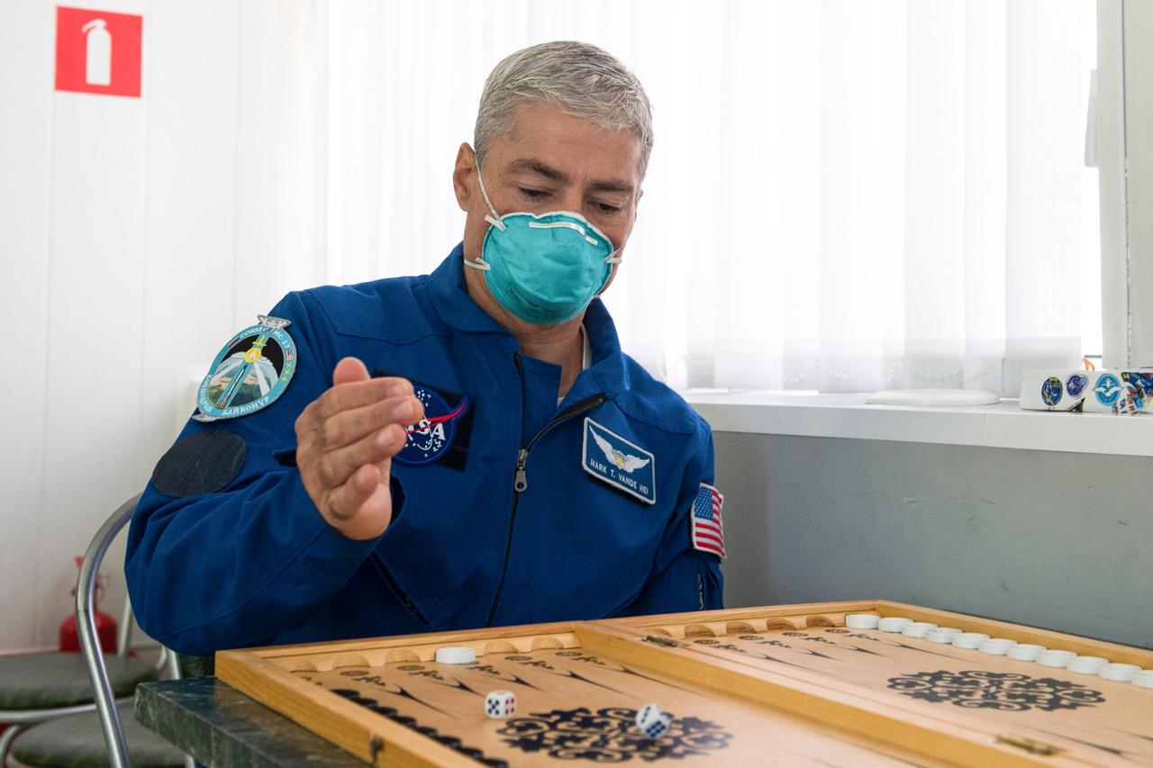 nhq202010060011 (Oct. 6, 2020) --- Expedition 64 backup crew member Mark Vande Hei of NASA plays a game of backgammon, Tuesday, Oct. 6, 2020, at the Cosmonaut Hotel in Baikonur, Kazakhstan. The Expedition 64 prime crew of Russian cosmonauts Sergey Ryzhikov and Sergey Kud-Sverchkov of Roscosmos, and NASA astronaut Kate Rubins, are scheduled to launch to the International Space Station aboard the Soyuz MS-17 spacecraft on October 14. Photo Credit: (NASA/GCTC/Andrey Shelepin)