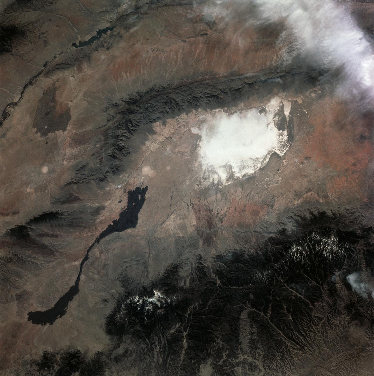 STS003-10-613 (22-30 March 1982) --- A truly remarkable view of White Sands and the nearby Carrizozo Lava Beds in southeast NM (33.5N, 106.5W). White Sands, site of the WW II atomic bomb development and testing facility and later post war nuclear weapons testing that can still be seen in the cleared circular patterns on the ground. Space shuttle Columbia (STS-3), this mission, landed at the White Sands alternate landing site because of bad weather at Edwards AFB, CA. Photo credit: NASA