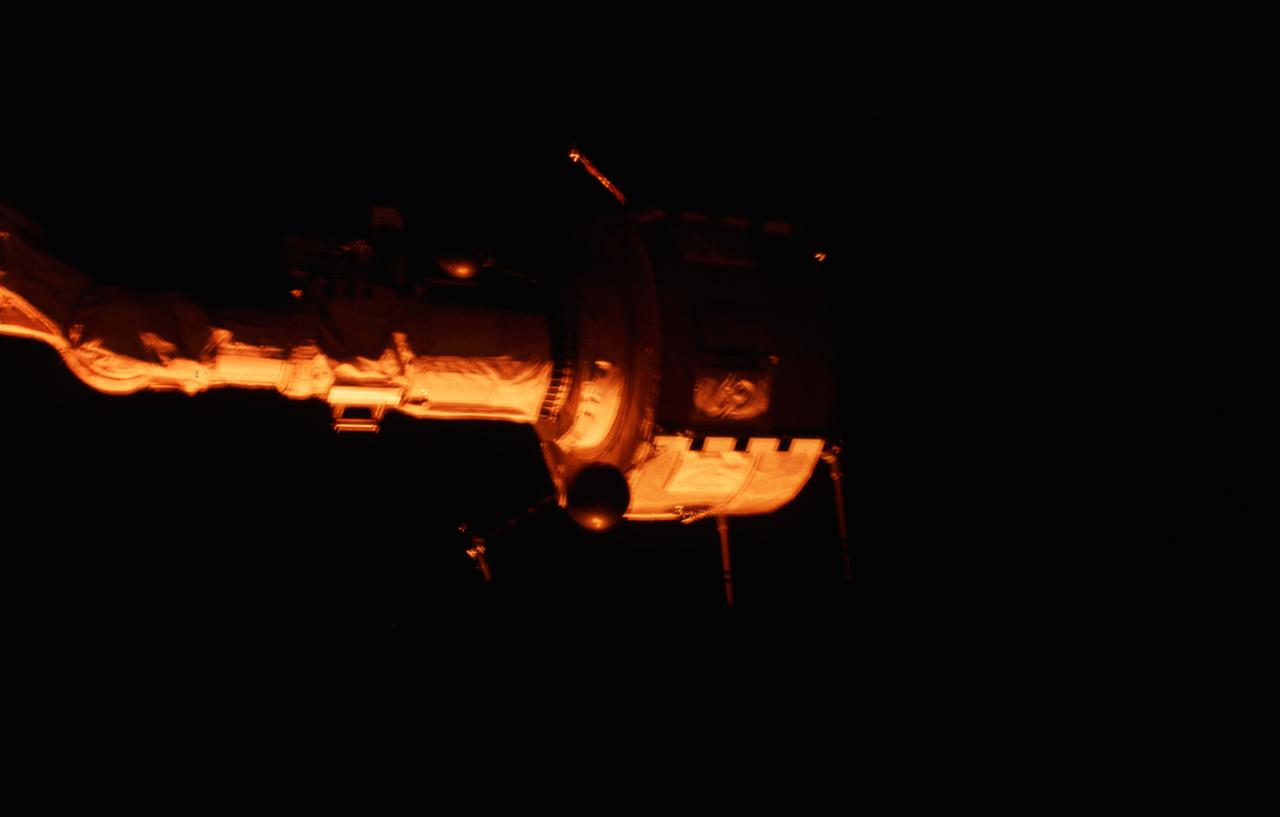 STS003-21-080 (22-30 March 1982) --- Plasma Diagnostics Package (PDP) grappled by remote manipulator system (RMS) end effector is positioned above payload bay (PLB) at sunrise. Photo credit: NASA