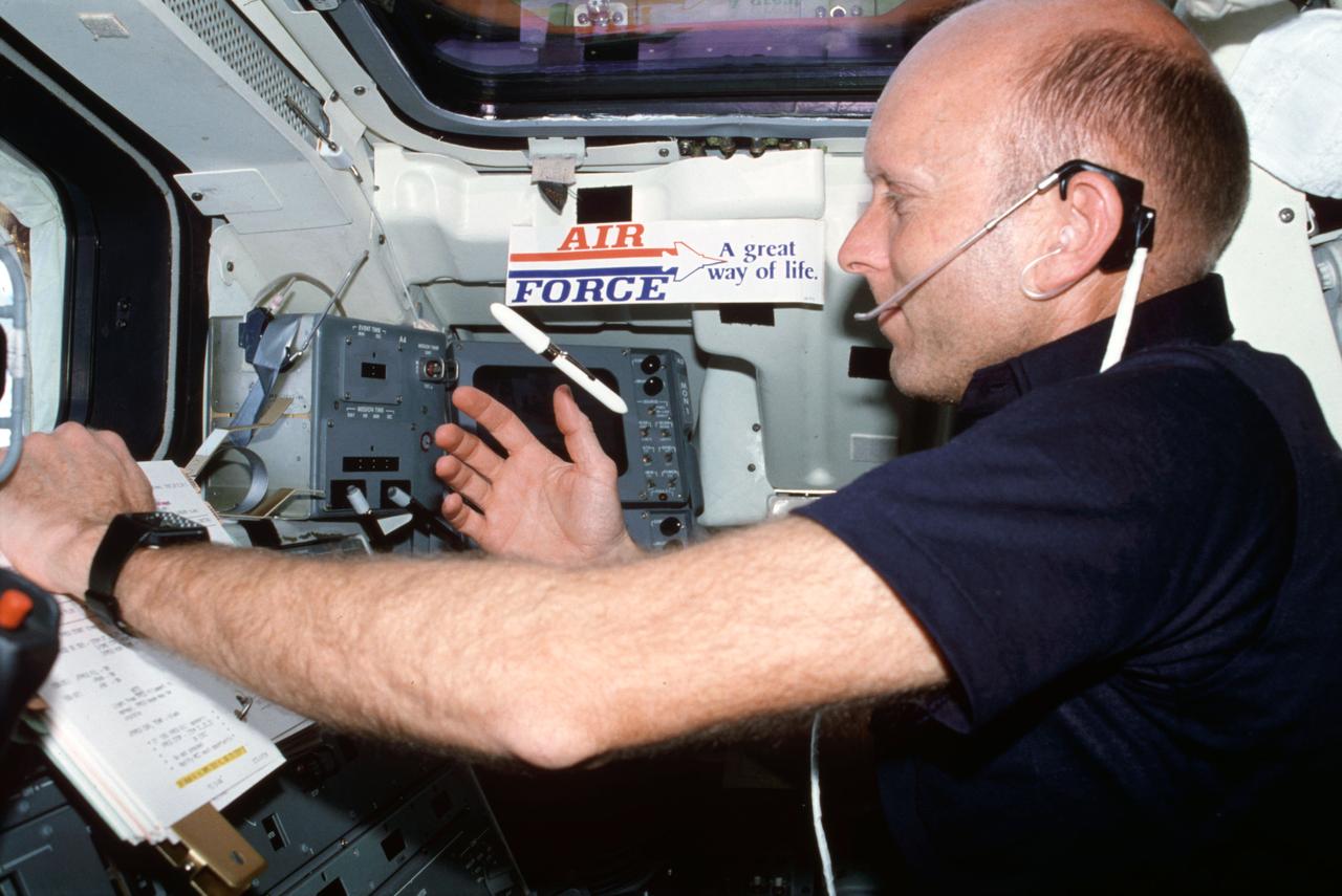 STS003-21-086 (22-30 March 1982) --- Astronaut Gordon Fullerton, STS-3 pilot, wearing communications kit assembly mini-headset, watches a free-floating pen during checklist procedures at the aft flight deck on-orbit station. Taken from the aft flight deck starboard side, Fullerton is seen in front of panels A7 and A8 with W8 and a "United States Air Force - a Great Way of Life" decal overhead. Photo credit: NASA