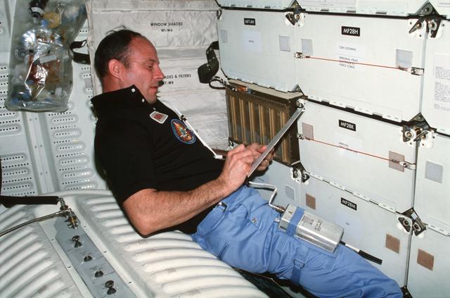NASA image: Commander Lousma records PGU data on middeck