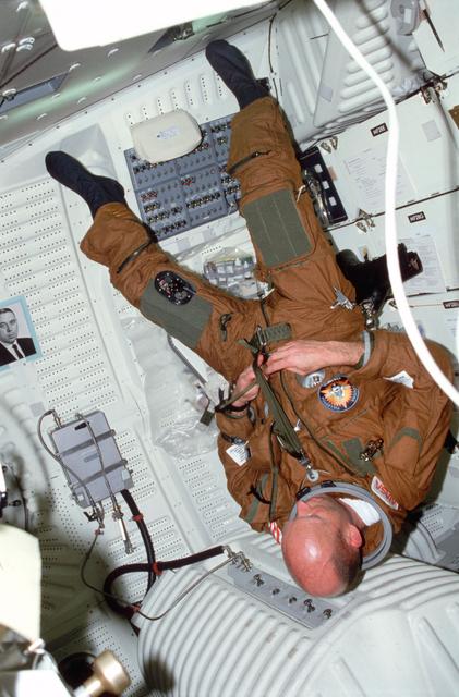 NASA image: Pilot Fullerton dons ejection escape suit (EES) on middeck