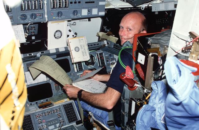 NASA image: Pilot Fullerton reviews FDF and TAGS printout on forward flight deck