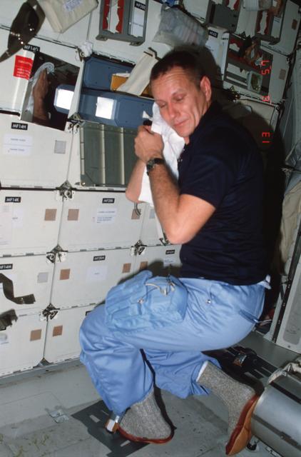 NASA image: Pilot Overmyer completes hygiene activities / demostrates IVA foot restraint