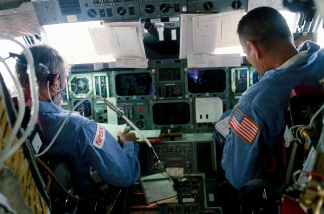 NASA image: Commander Brand and Pilot Overmyer operate controls on forward flight deck