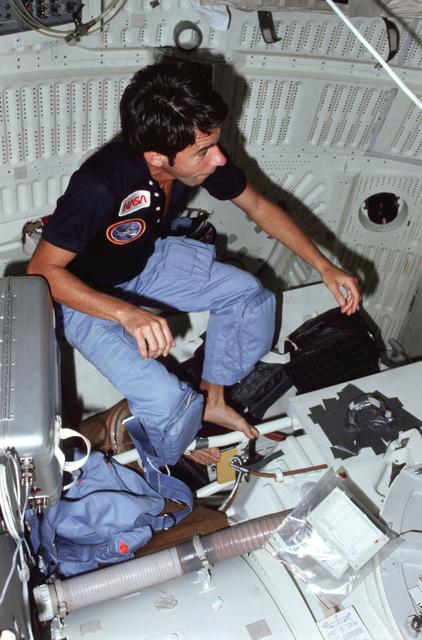 NASA image: MS Lenoir observes middeck activities from interdeck access ladder