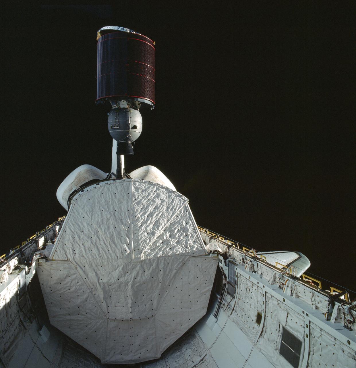 STS005-41-1311 (17 Nov. 1982) --- The Telesat Canada's ANIK C-3 satellite is deployed from its protective cradle in the cargo bay of the space shuttle Columbia. Part of Columbia's wings can be seen on both the port and starboard sides. Part of both orbital maneuvering system (OMS) pods are seen at center. The vertical stabilizer is obscured by the satellite. Photo credit: NASA