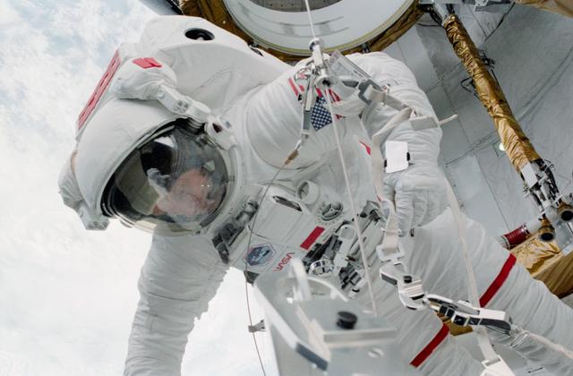 NASA image: MS Musgrave adjusts EVA crewmember safety tether reel in aft PLB