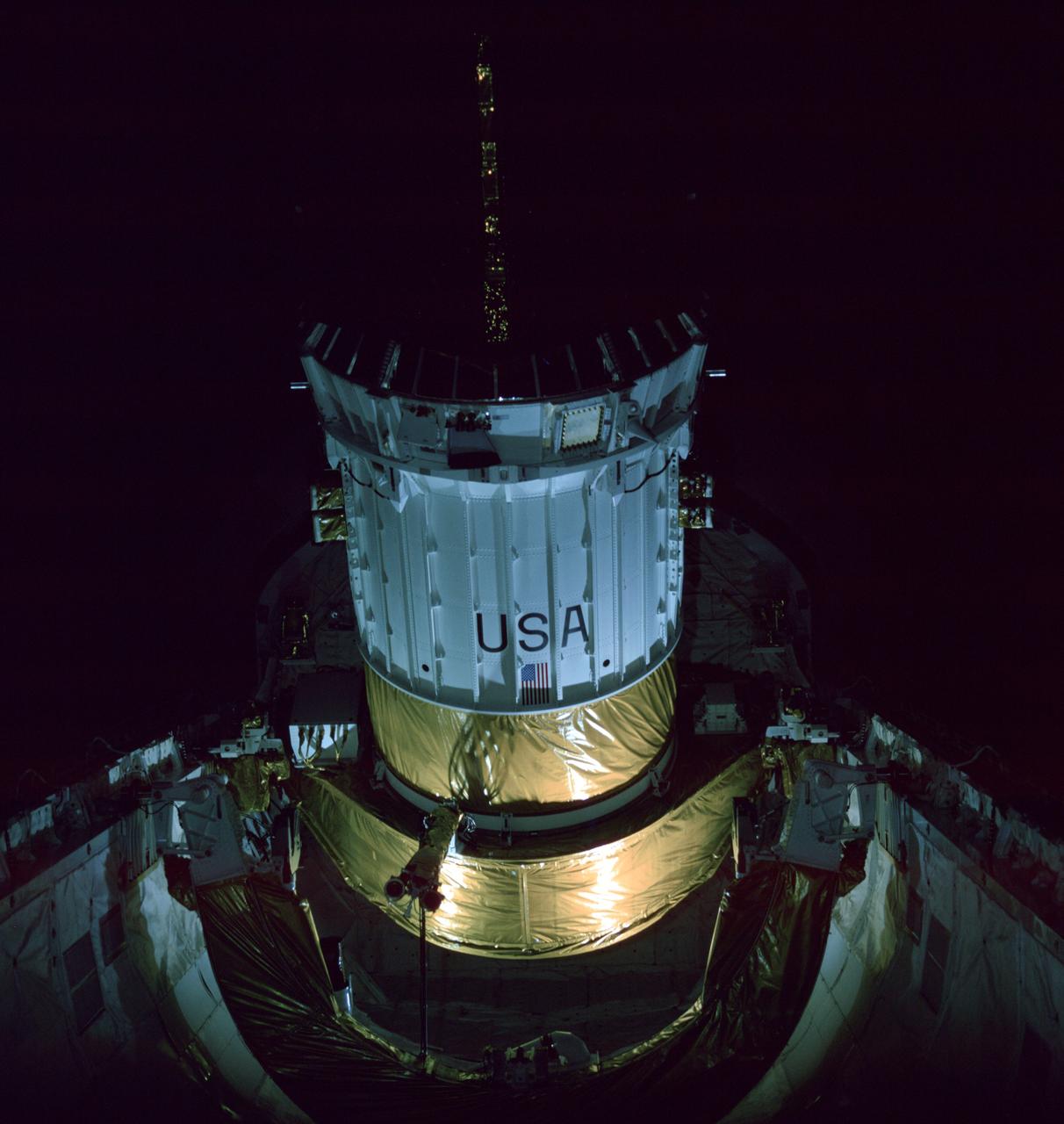 STS006-40-685 (4 April 1983) --- This view of a tilted tracking and data relay satellite (TDRS) and part of its inertial upper stage (IUS) was photographed during deployment of the TDRS/IUS tandem some 10 hours following launch of space shuttle Challenger. A 70mm camera was aimed by crew members through the aft windows of the Earth-orbiting Challenger to capture the scene. A tilt-table device was used to lift the TDRS to this position (almost 90 degrees different from its stowed position). Onboard NASA’s second reusable shuttle for this five-day flight were astronauts Paul J. Weitz, Karol J. Bobko, Dr. F. Story Musgrave and Donald H. Peterson. Photo credit: NASA
