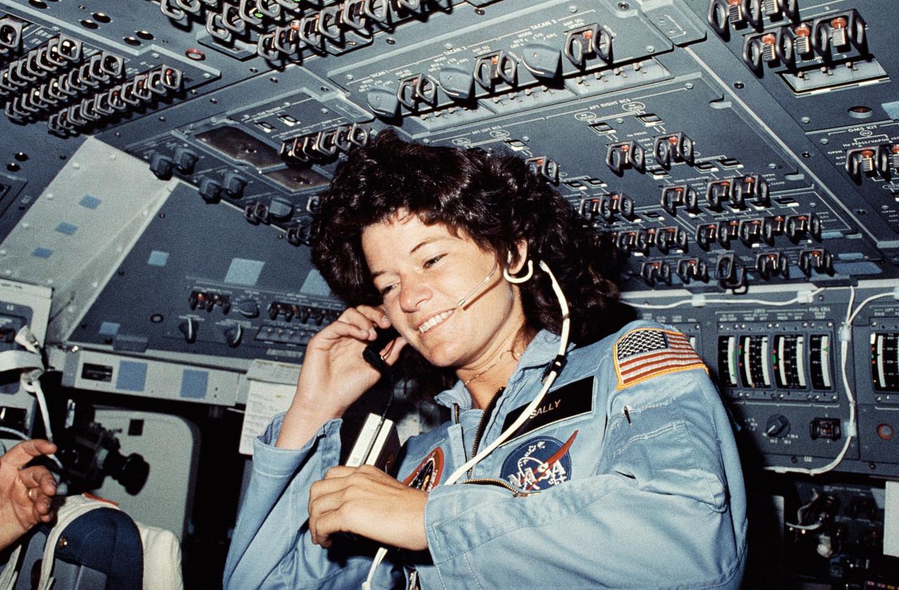 STS007-02-027  (21 June 1983) --- Astronaut Sally K. Ride, STS-7 mission specialist,  communicates with ground controllers from the flight deck of the Earth-orbiting Space  Shuttle Challenger.