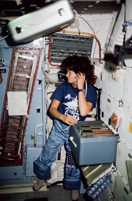 NASA image: Mission Specialist (MS) Ride adjusts headset (HDST) on middeck