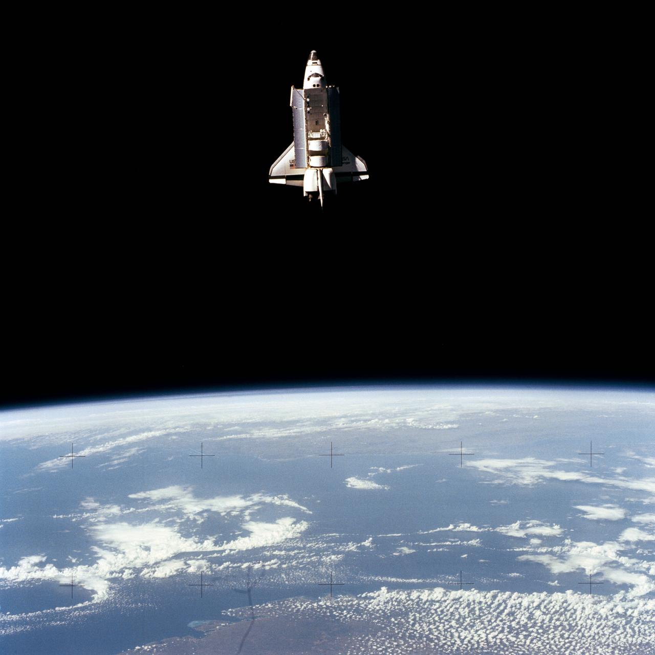 STS007-32-1702 (22 June 1983) --- The Earth-orbiting space shuttle Challenger beyond the Earth's horizon was captured by a 70mm camera onboard the unmanned, free-flying Shuttle Pallet Satellite (SPAS-01) during the busy flight day 5 of the STS-7 mission. Visible in the cargo bay are the protective cradles for the now-vacated Telesat Anik C-2 and Palapa B communications satellites, the pallet for the NASA Office of Space and Terrestrial Applications (OSTA-02), the Remote Manipulator System (RMS) and the KU-Band antenna. The STS-7 crew with the RMS later retrieved the SPAS and returned it to a stowed position in the cargo bay for return to Earth. Photo credit: NASA or National Aeronautics and Space Administration