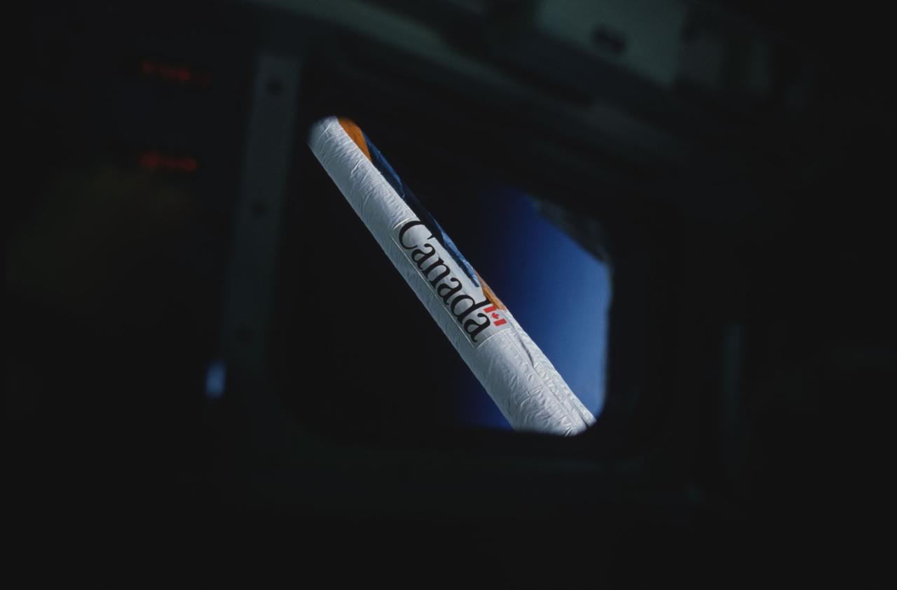 STS008-04-098 (30 Aug-5 Sept 1983) --- A portion of the Canadian-built remote manipulator system (RMS) arm is centered in this frame, photographed through a window on the flight deck of the Earth-orbiting Space Shuttle Challenger.  The arm was getting a workout with the payload flight test article (PFTA), which joined the five-member astronaut crew on the six-day mission in space.