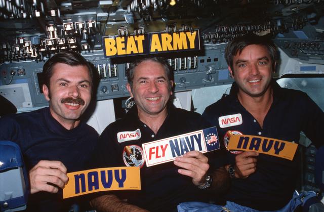 NASA image: U.S. Navy crew members display decals on forward flight deck