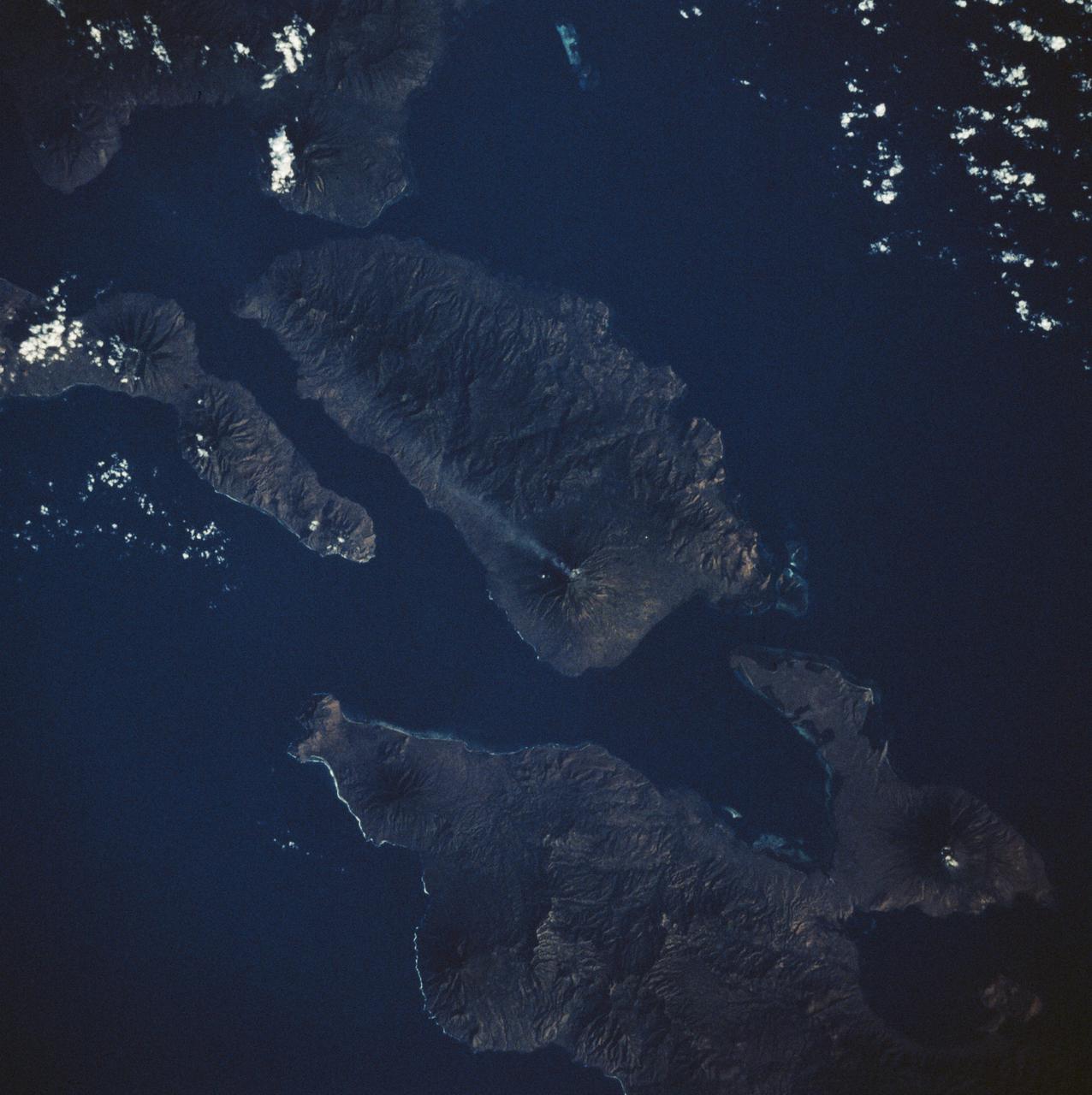 STS008-50-1840 (30 Aug-5 Sept 1983) --- An active 5,500 foot high volcano on Adonara Island in Indonesia leaves a 30 mile long visible trail of smoke.  The surrounding islands are Flores (lower right) Solor (right edge) and Lomblen (upper center).  This photograph was made from the Earth orbiting Space Shuttle Challenger on its third mission.