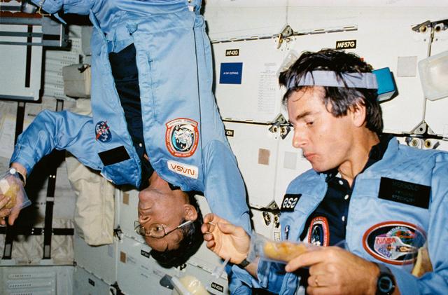 NASA image: Astronauts Young and Merbold have meal in the middeck of Columbia