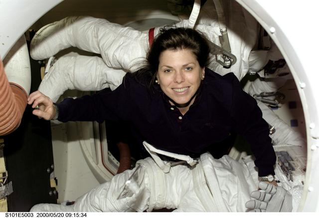 NASA image: MS Weber in airlock with Extravehicular Mobility Unit (EMU) hardware