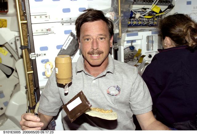 NASA image: PLT Horowitz on middeck with jar of peanut butter